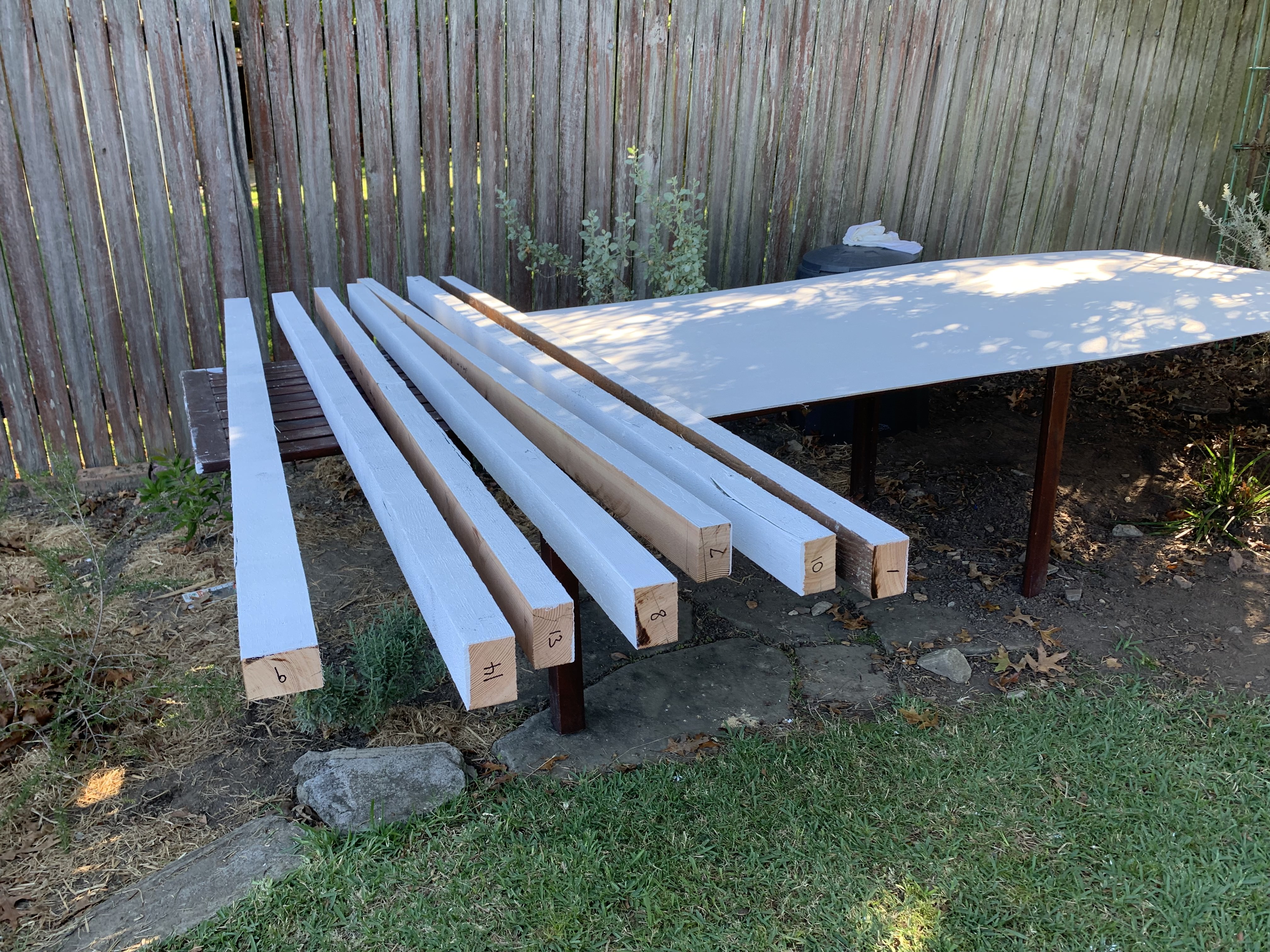 Priming the floor joists and plywood