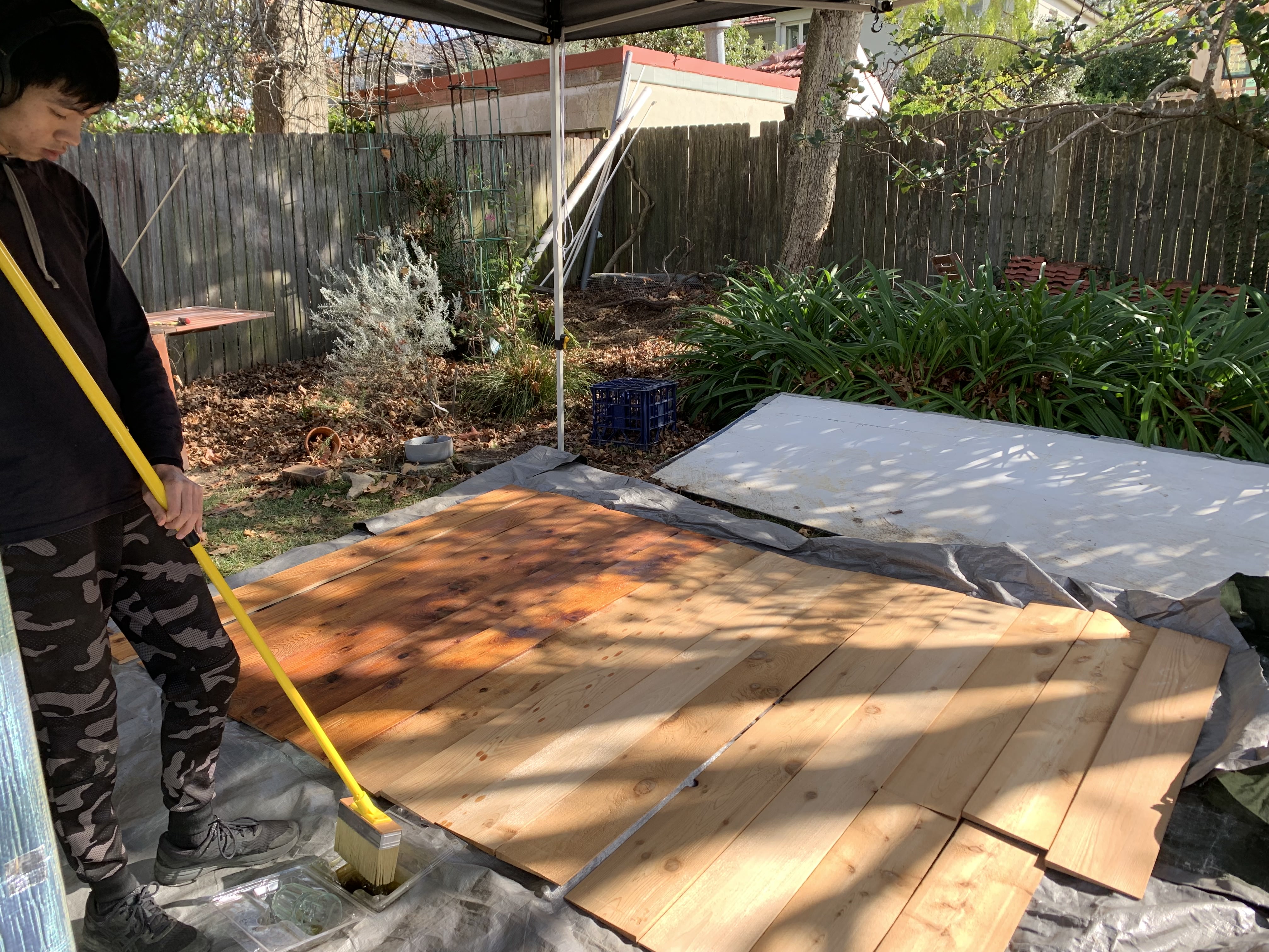 Tom working hard oiling the cladding boards over the weekend